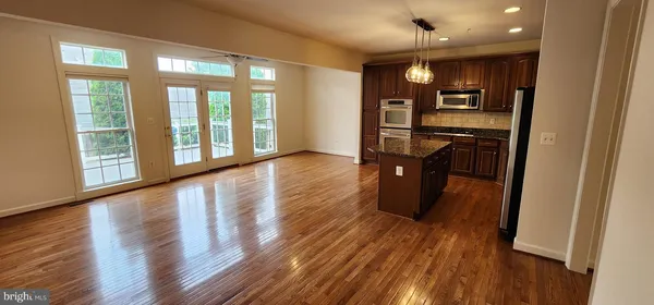 a view of a kitchen with furniture and wooden floor