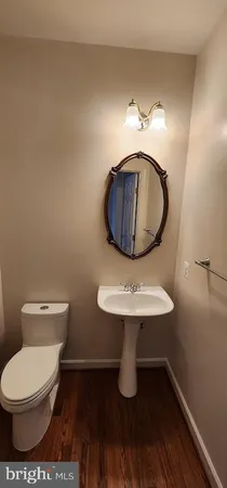 a bathroom with a toilet a sink and mirror