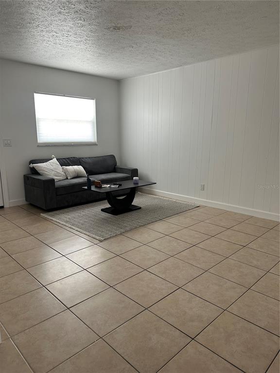 1909 West Green Street Tampa, FL 33607 - Photo 3 of 9 a living room with a couch and a window
