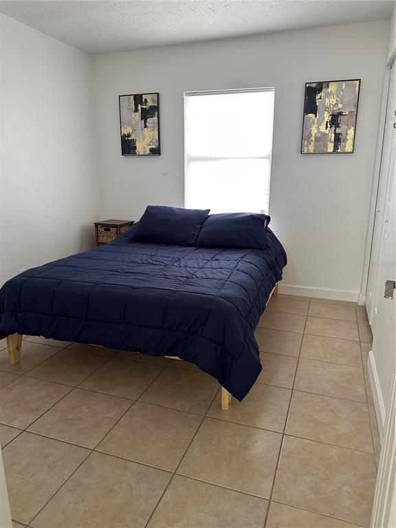 1909 West Green Street Tampa, FL 33607 - Photo 7 of 9 a bedroom with a bed and a window