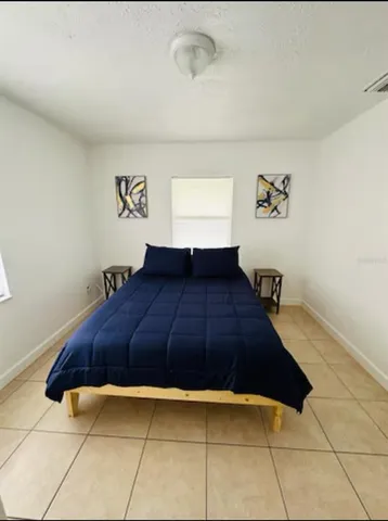 a bedroom with a bed and window