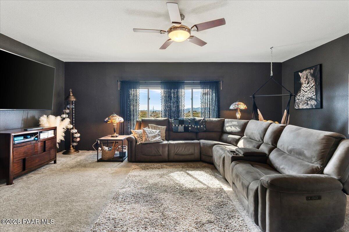 8475 West Red Rock Road Kirkland, AZ 86332 - Photo 13 of 39 a living room with furniture or chandelier and a flat screen tv