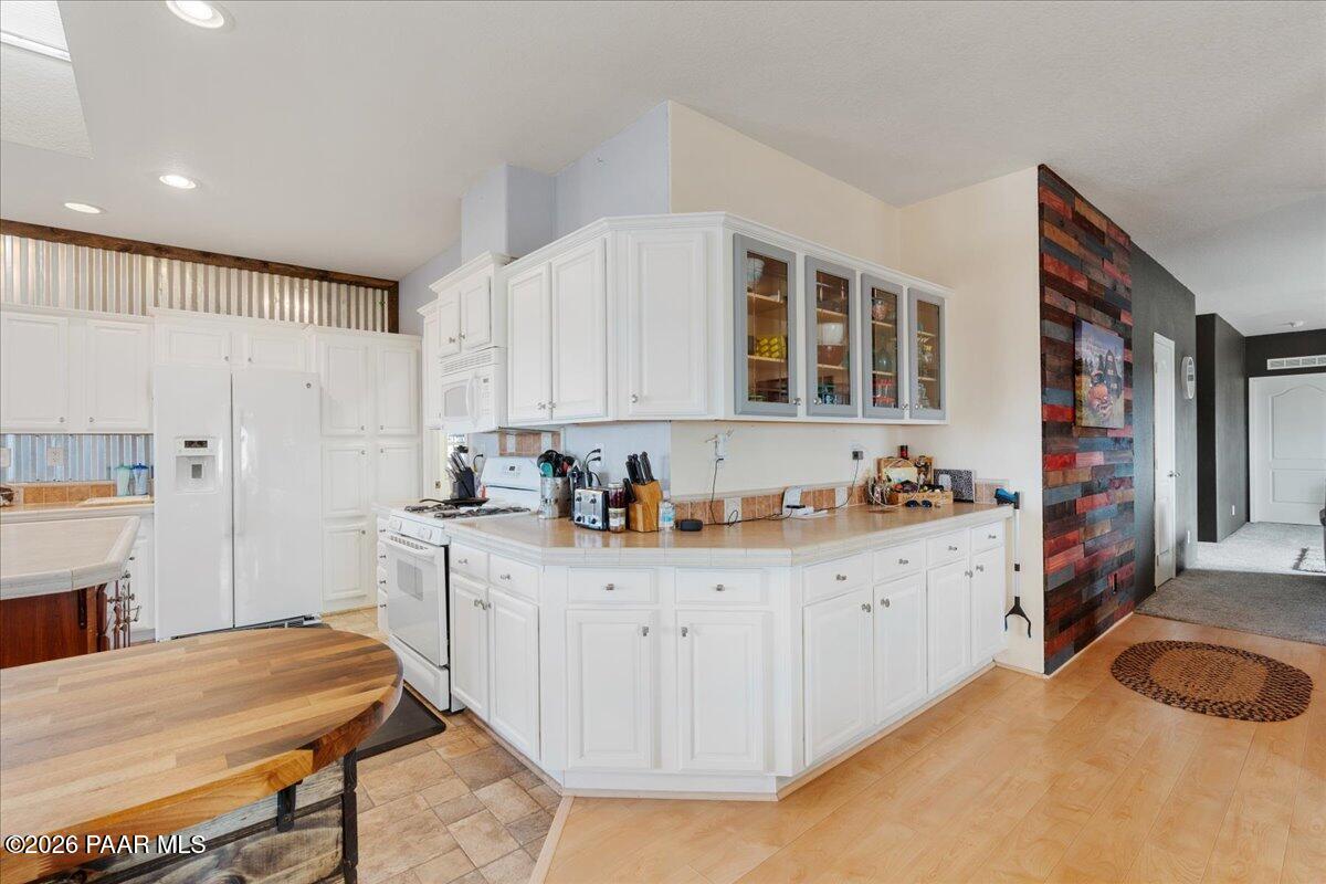 8475 West Red Rock Road Kirkland, AZ 86332 - Photo 18 of 39 a kitchen with granite countertop a sink stove and cabinets
