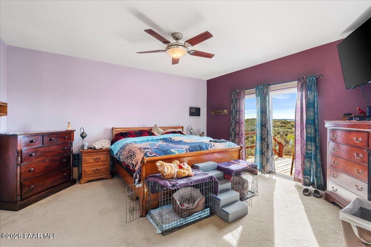 8475 West Red Rock Road Kirkland, AZ 86332 - Photo 22 of 39 a bedroom with a bed and a chandelier
