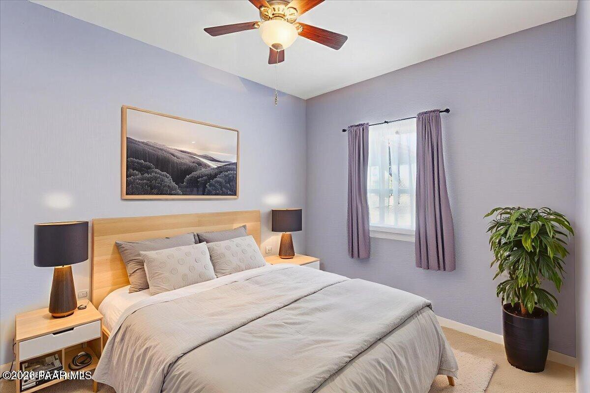 8475 West Red Rock Road Kirkland, AZ 86332 - Photo 25 of 39 a bedroom with a bed and a chandelier