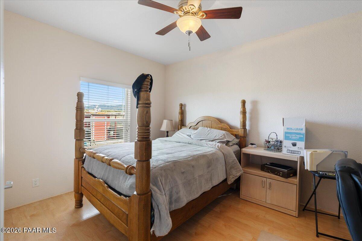 8475 West Red Rock Road Kirkland, AZ 86332 - Photo 27 of 39 a bedroom with a bed and a chandelier