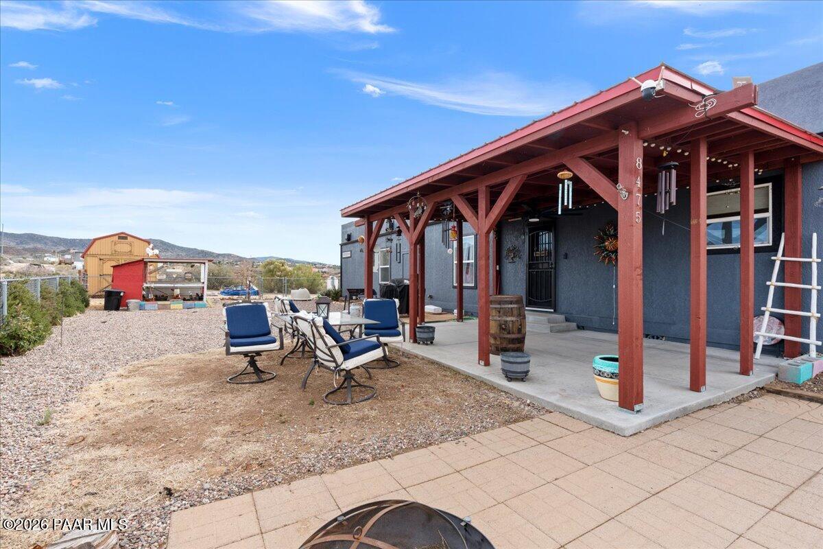 8475 West Red Rock Road Kirkland, AZ 86332 - Photo 31 of 39 a view of a patio with table and chairs near a barbeque