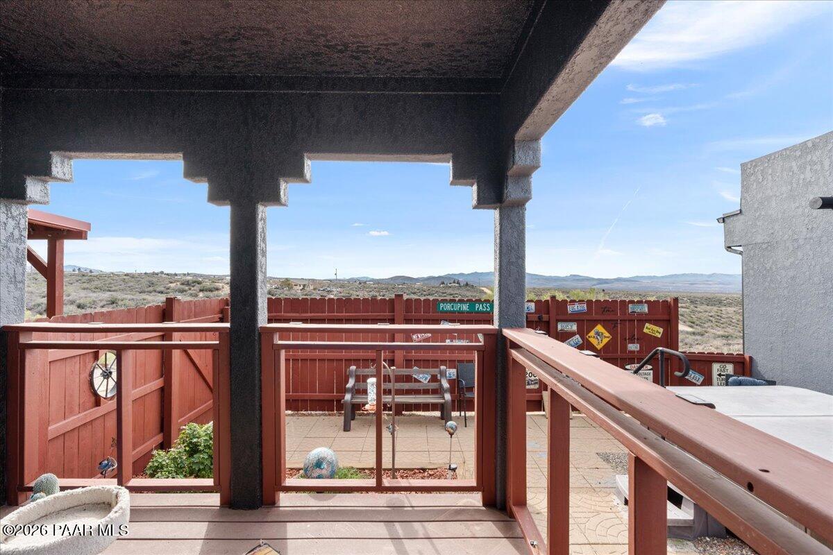 8475 West Red Rock Road Kirkland, AZ 86332 - Photo 7 of 39 a view of a balcony with a floor to ceiling window with wooden floor