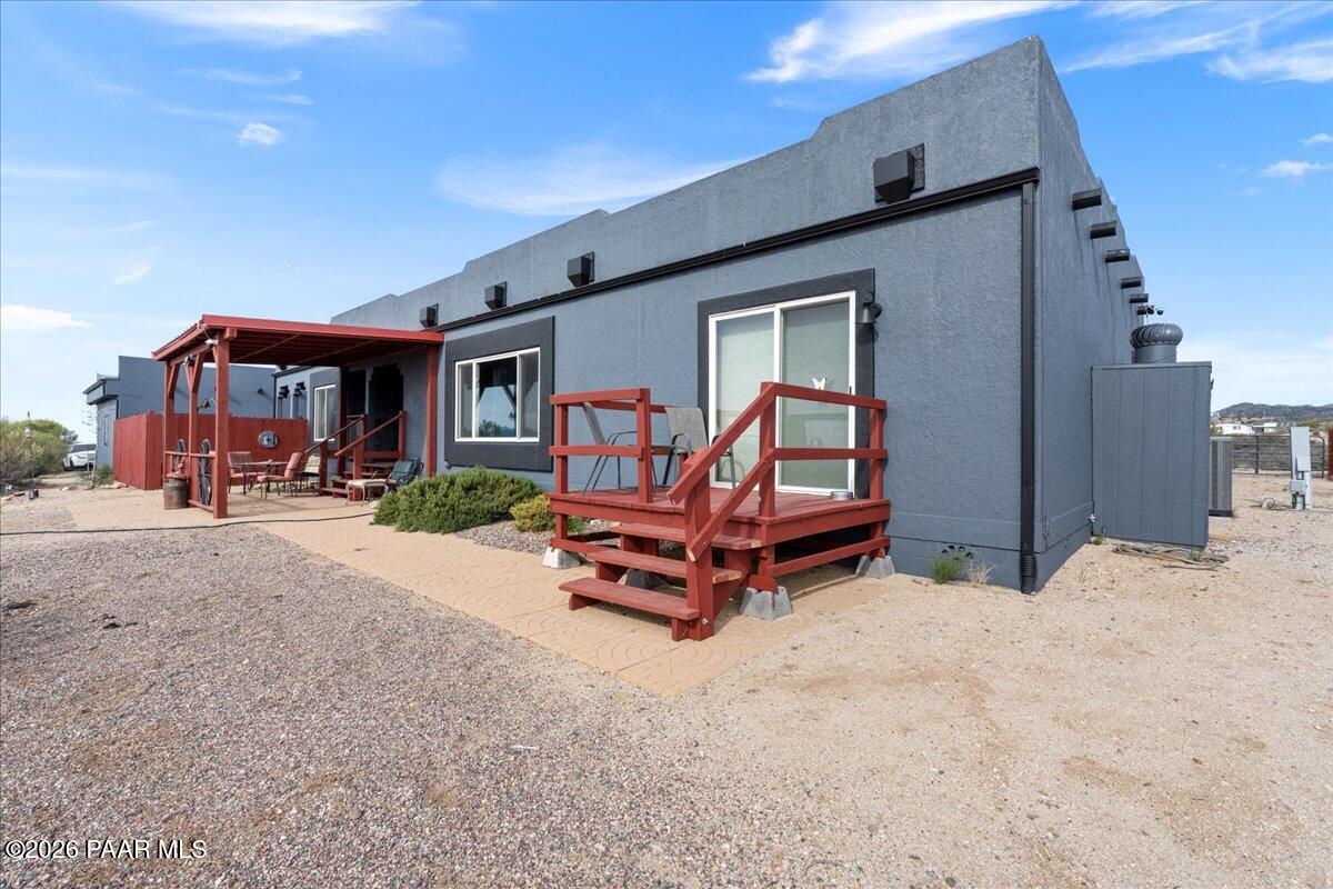 8475 West Red Rock Road Kirkland, AZ 86332 - Photo 9 of 39 a backyard of a house with barbeque oven table and chairs