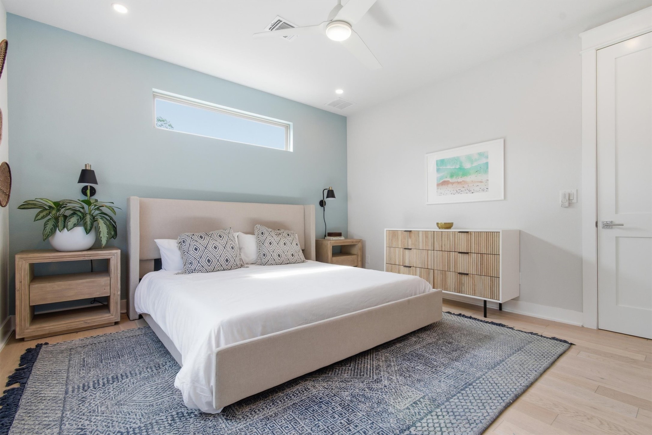 2710 Zaragosa Street, Unit A Austin, TX 78702 - Photo 15 of 29 Light-filled bedroom with high windows and a calm, neutral palette — room to live and unwind.