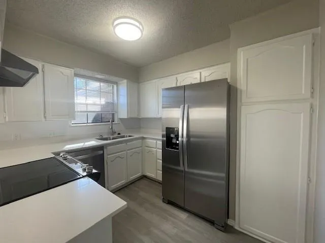 a kitchen with a sink stove and refrigerator