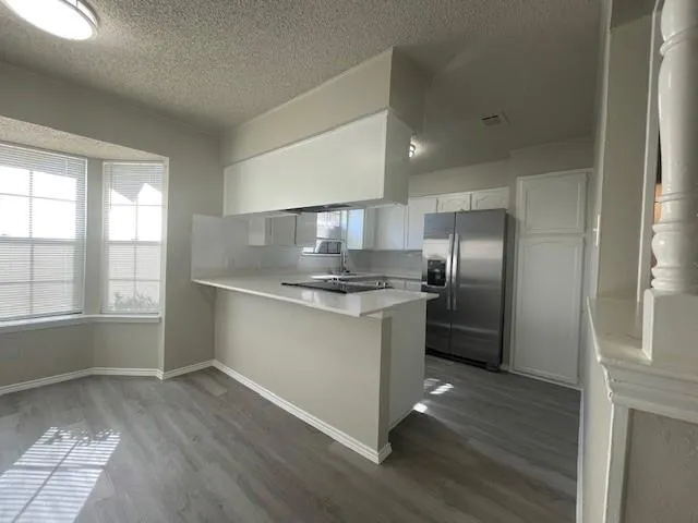 a kitchen with stainless steel appliances granite countertop a refrigerator and a sink