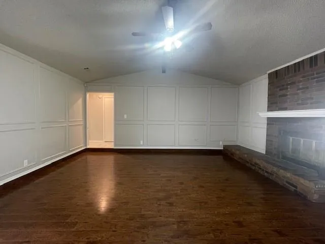 a view of a room with wooden floor and window