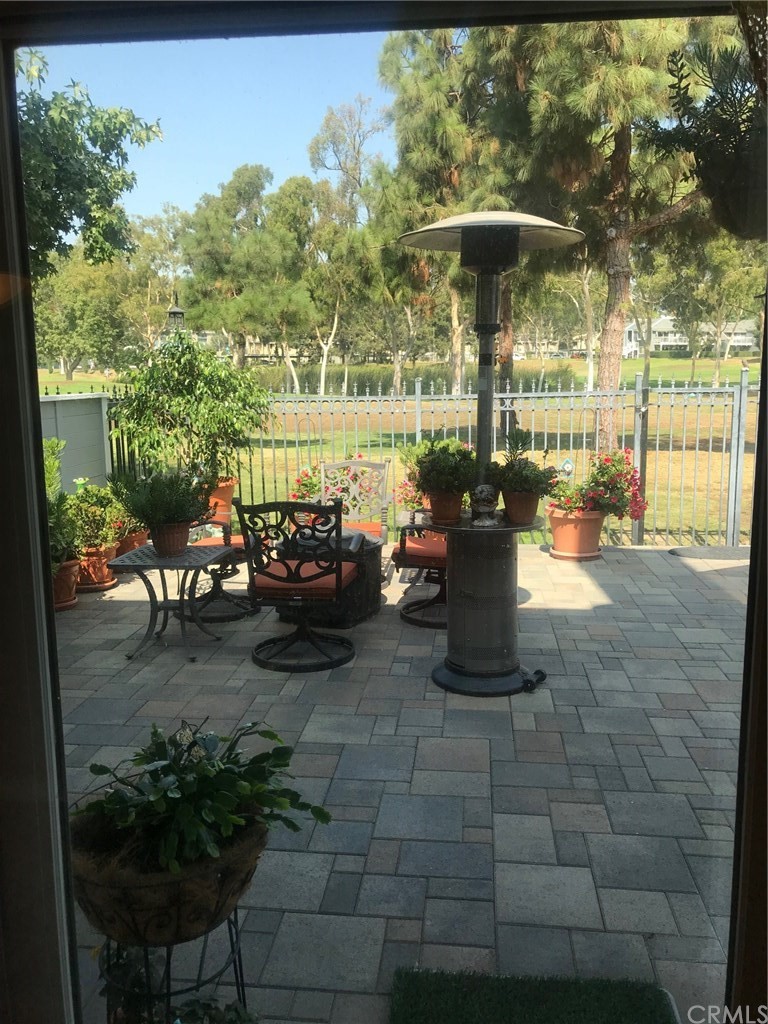 6053 Loynes Drive Long Beach, CA 90803 - Photo 12 of 21 a view of a patio with table and chairs potted plants with wooden floor