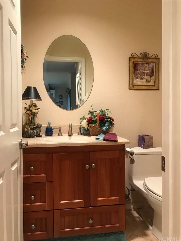 6053 Loynes Drive Long Beach, CA 90803 - Photo 20 of 21 a bathroom with a toilet sink vanity and mirror