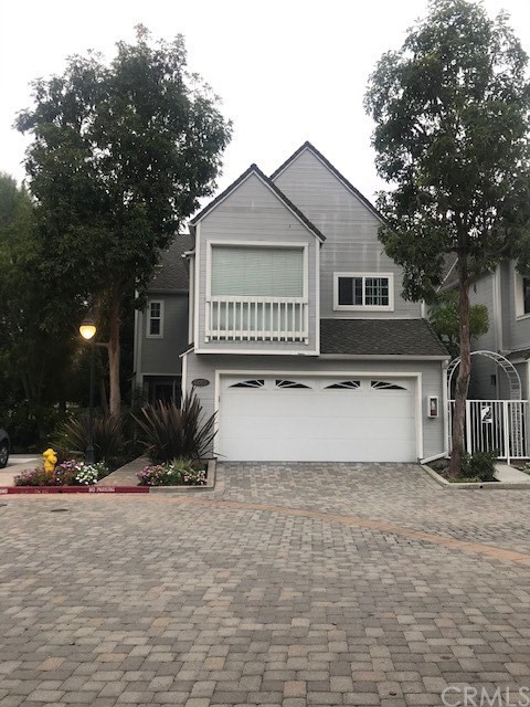 6053 Loynes Drive Long Beach, CA 90803 - Photo 2 of 21 a front view of a house with a yard and garage