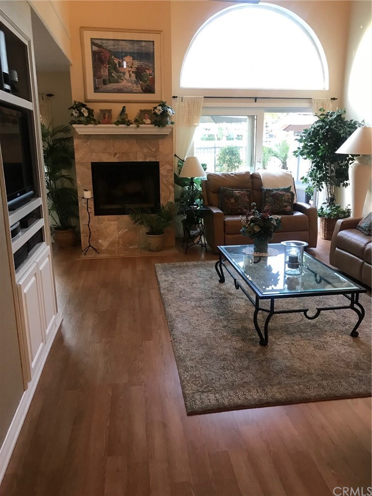 6053 Loynes Drive Long Beach, CA 90803 - Photo 21 of 21 a living room with furniture a window and a fireplace