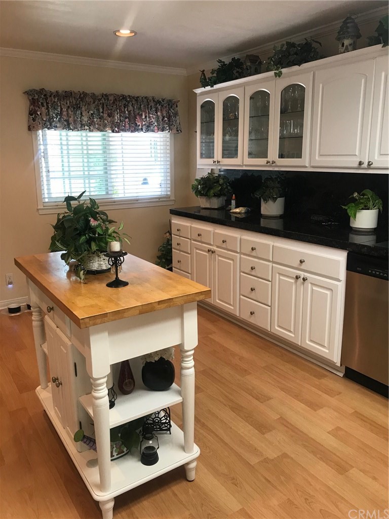 6053 Loynes Drive Long Beach, CA 90803 - Photo 3 of 21 a kitchen with stainless steel appliances a stove a sink and a cabinets