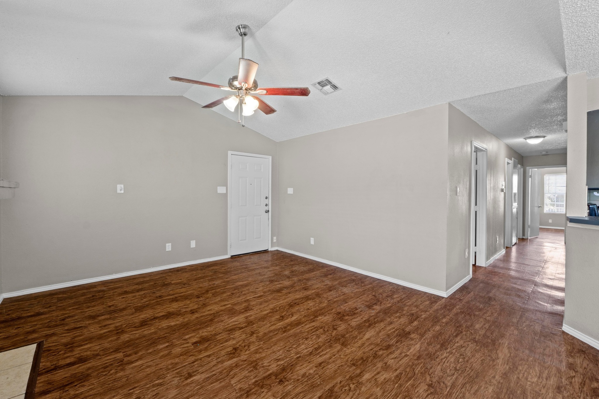 4208 Duval Road, Unit C Austin, TX 78759 - Photo 6 of 28 Unfurnished room featuring a ceiling fan, wood finished floors, and lofted ceiling