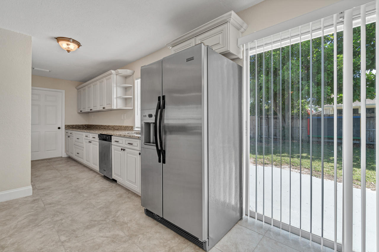 3526 Ivanhoe Avenue Boynton Beach, FL 33436 - Photo 13 of 29 a kitchen with stainless steel appliances granite countertop a refrigerator and a sink