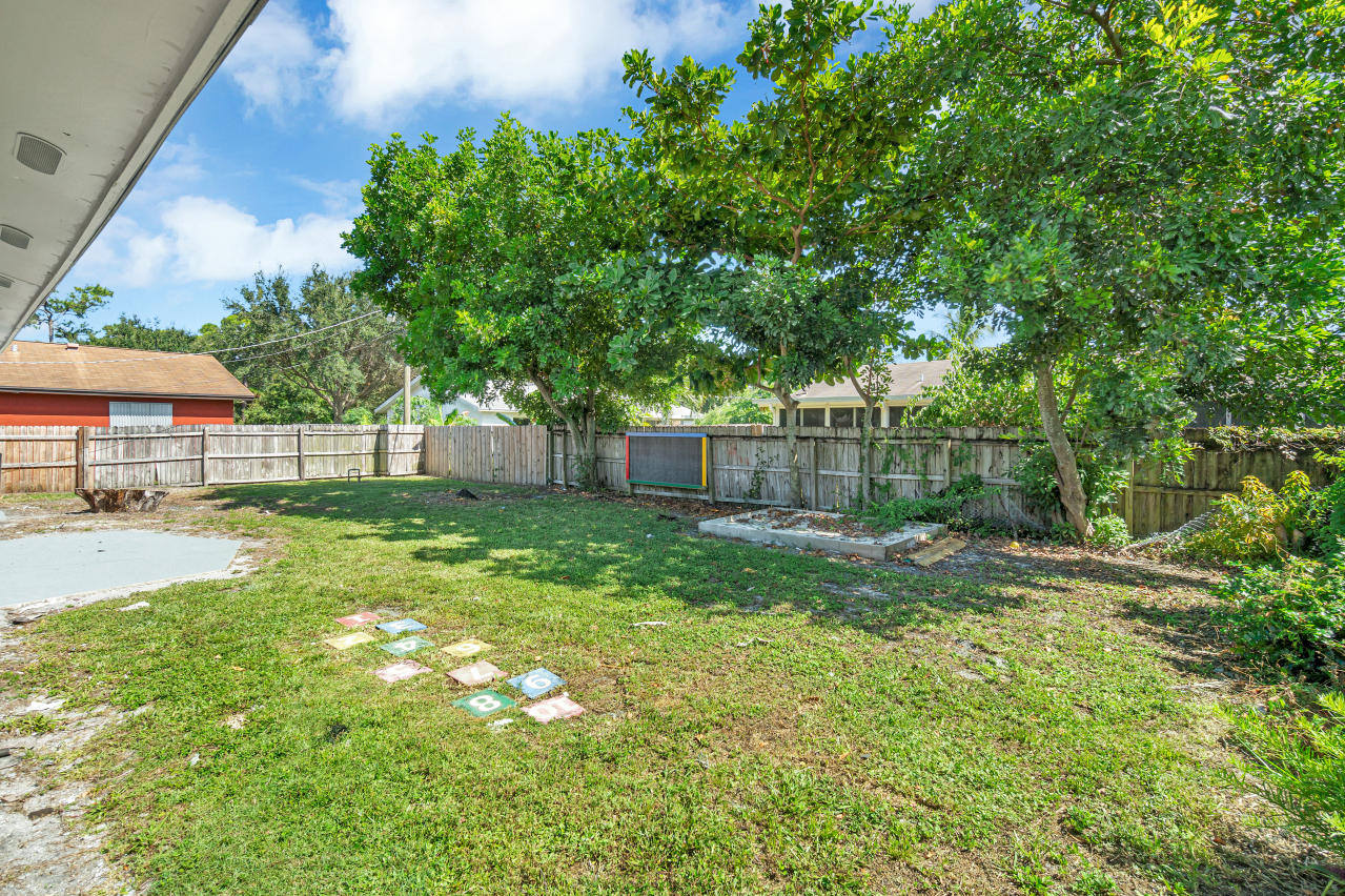3526 Ivanhoe Avenue Boynton Beach, FL 33436 - Photo 29 of 29 a view of backyard with table and chairs and wooden fence