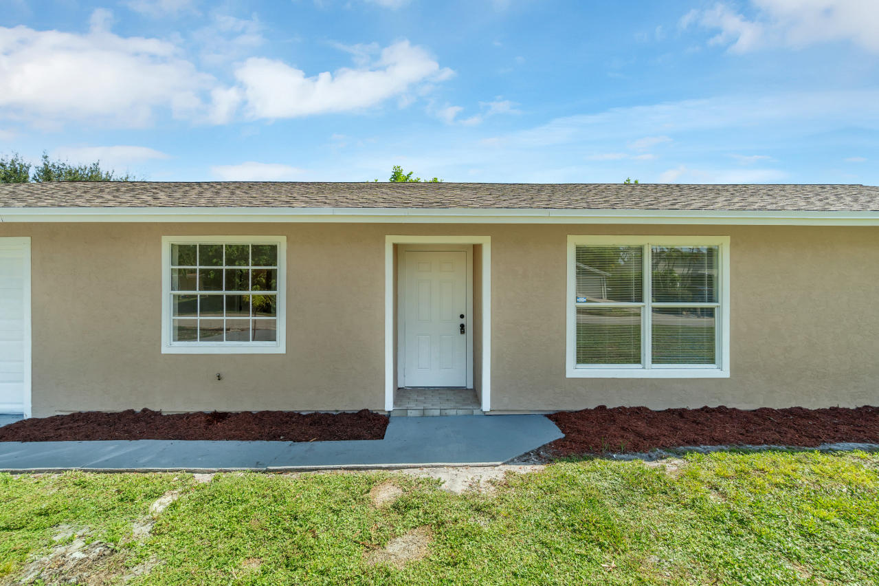 3526 Ivanhoe Avenue Boynton Beach, FL 33436 - Photo 4 of 29 a front view of a house with a yard