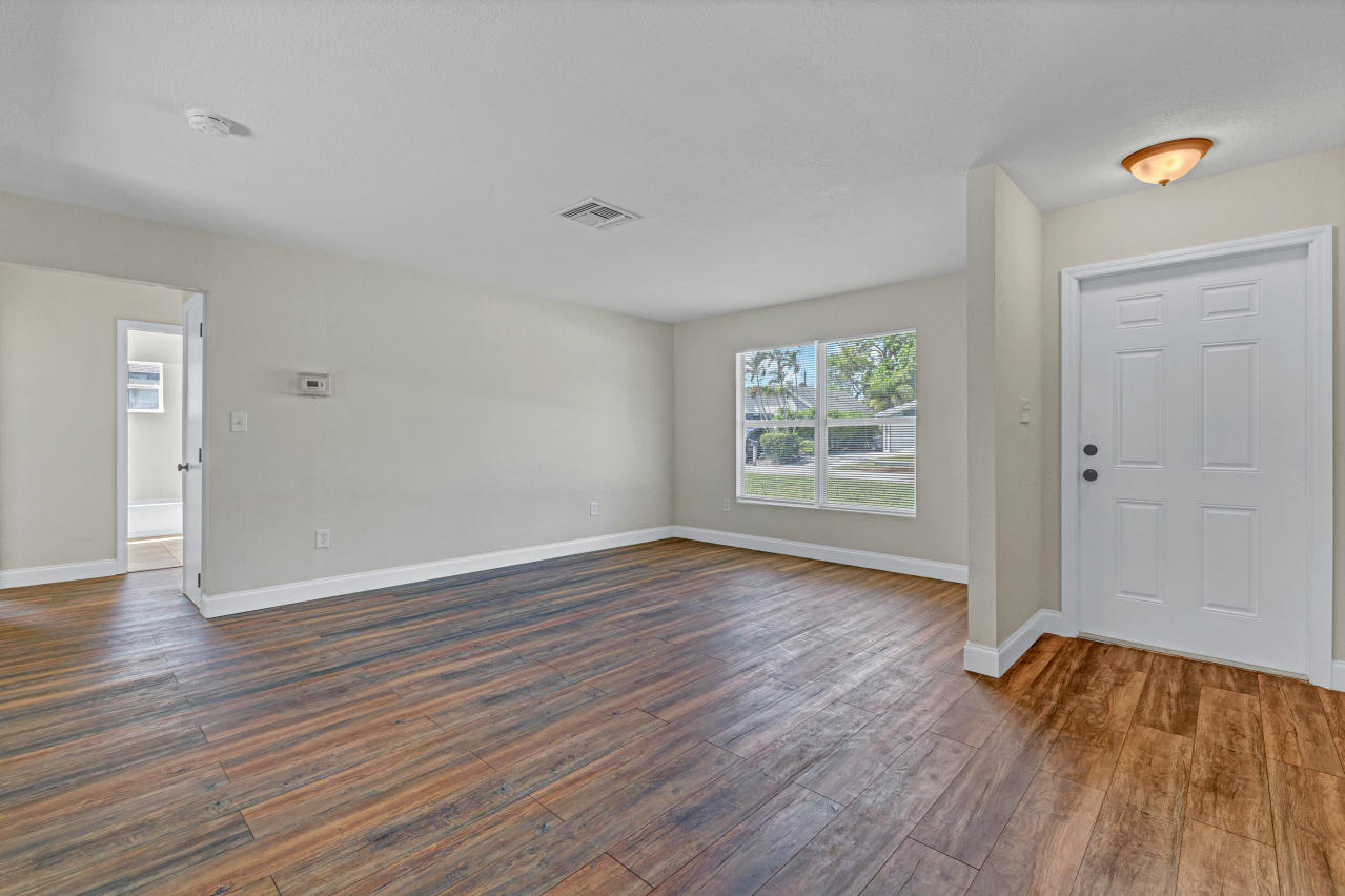 3526 Ivanhoe Avenue Boynton Beach, FL 33436 - Photo 5 of 29 an empty room with wooden floor and windows