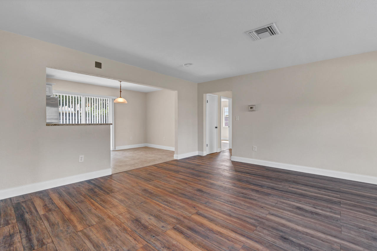 3526 Ivanhoe Avenue Boynton Beach, FL 33436 - Photo 7 of 29 a view of an empty room with wooden floor and a window