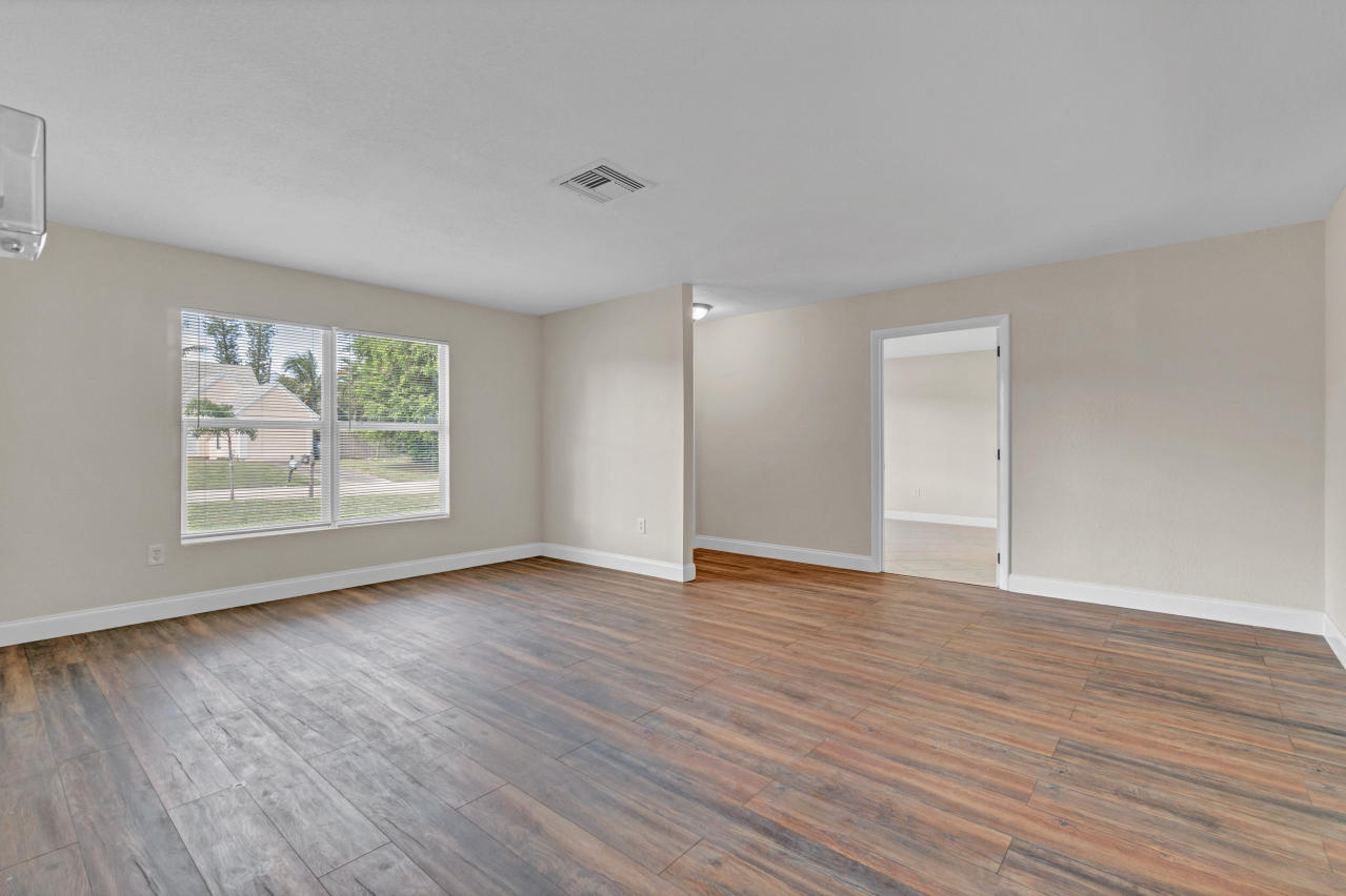 3526 Ivanhoe Avenue Boynton Beach, FL 33436 - Photo 8 of 29 an empty room with wooden floor and window