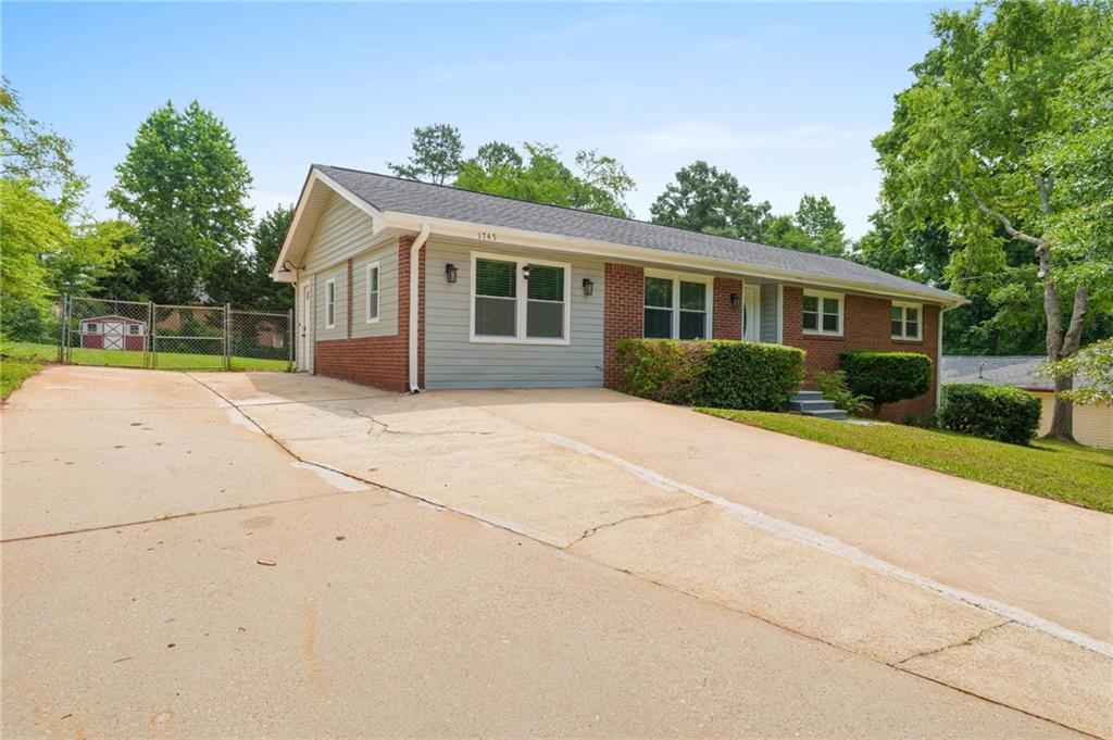 1745 Rockbridge Road Northwest Conyers, GA 30012 - Photo 2 of 32 a front view of house with yard and green space
