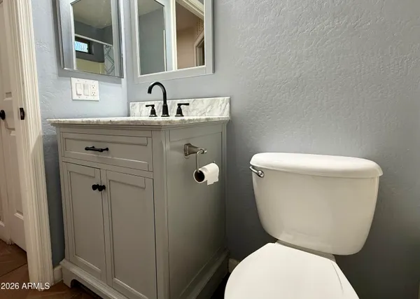 a white toilet sitting next to a bathroom sink