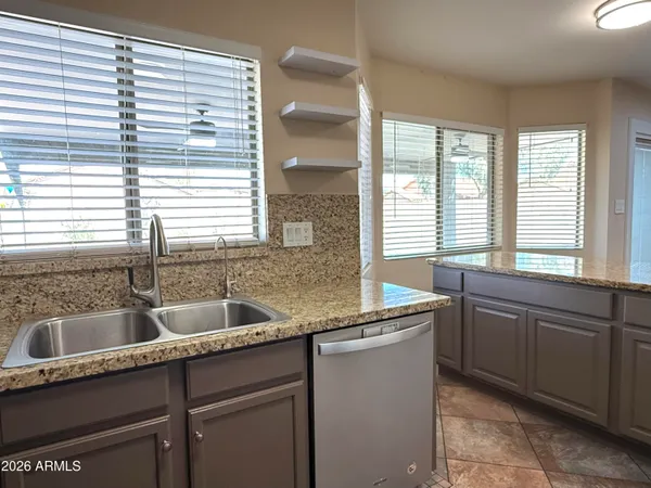 a kitchen with granite countertop a sink and a window