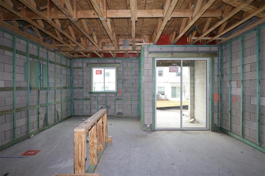 4723 Campsite Loop Orlando, FL 32824 - Photo 10 of 22 a view of an empty room with wooden floor and a window