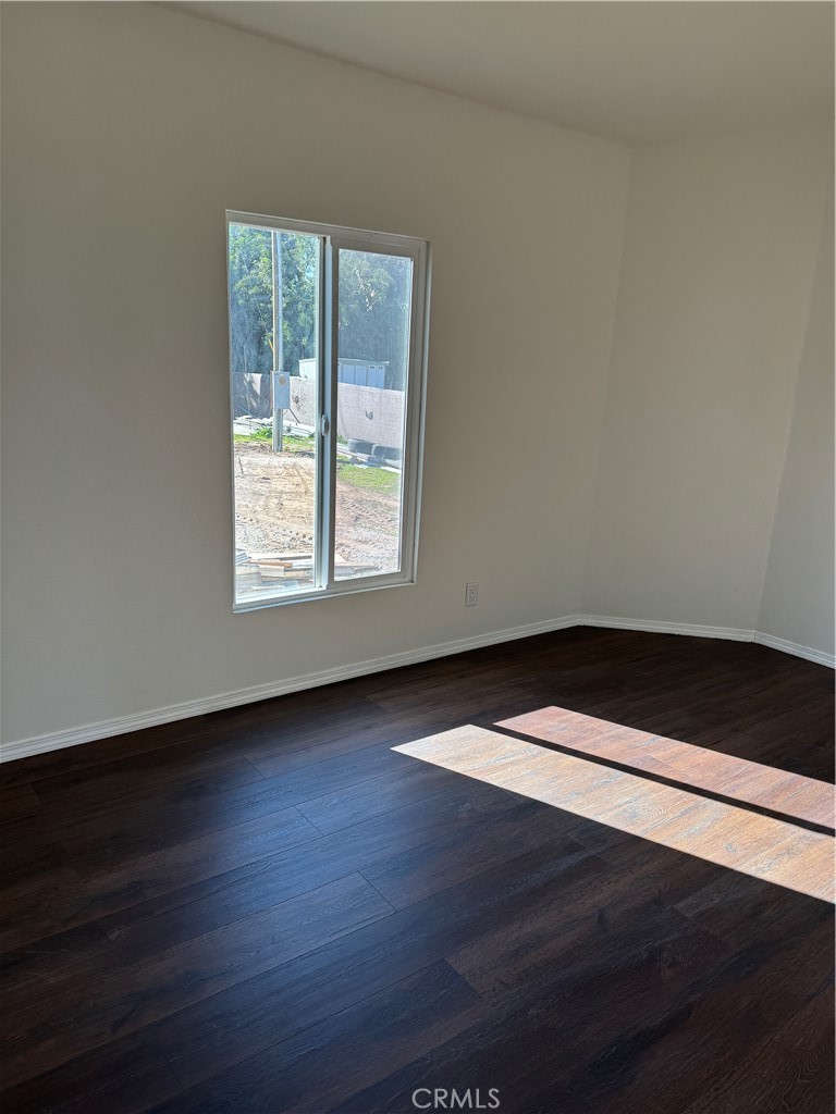28110 Winchester Road Winchester, CA 92596 - Photo 13 of 36 an empty room with wooden floor and windows
