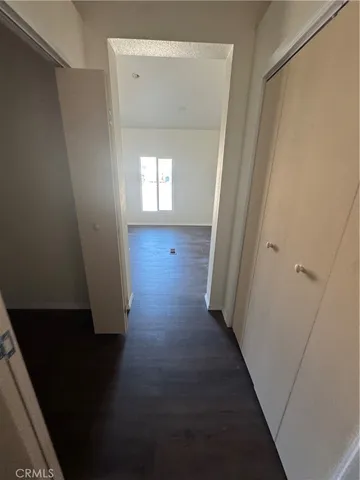 en empty room with wooden floor and a window