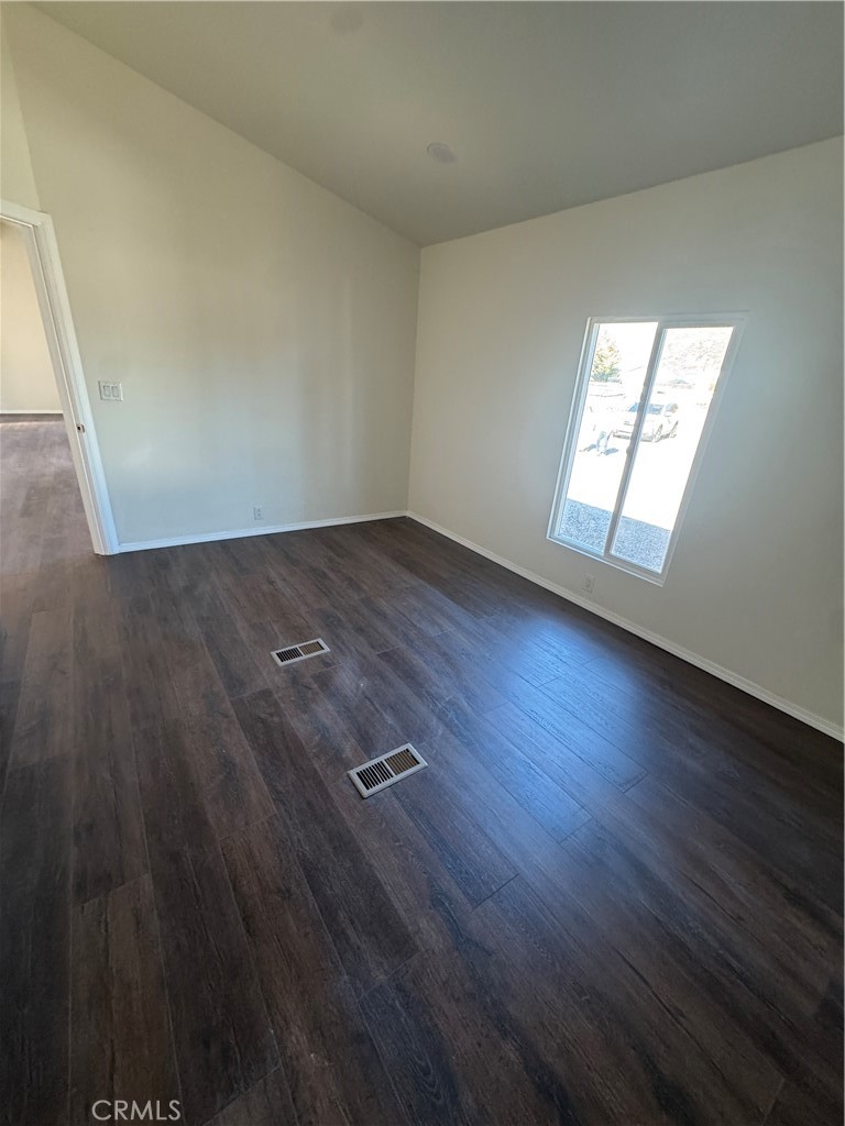 28110 Winchester Road Winchester, CA 92596 - Photo 24 of 36 an empty room with wooden floor and windows