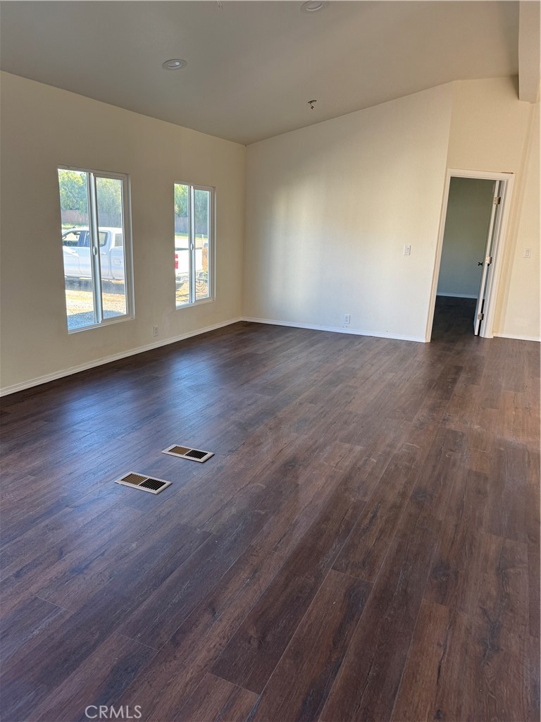 28110 Winchester Road Winchester, CA 92596 - Photo 35 of 36 an empty room with wooden floor and windows