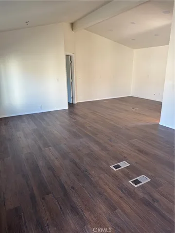 an empty room with wooden floor