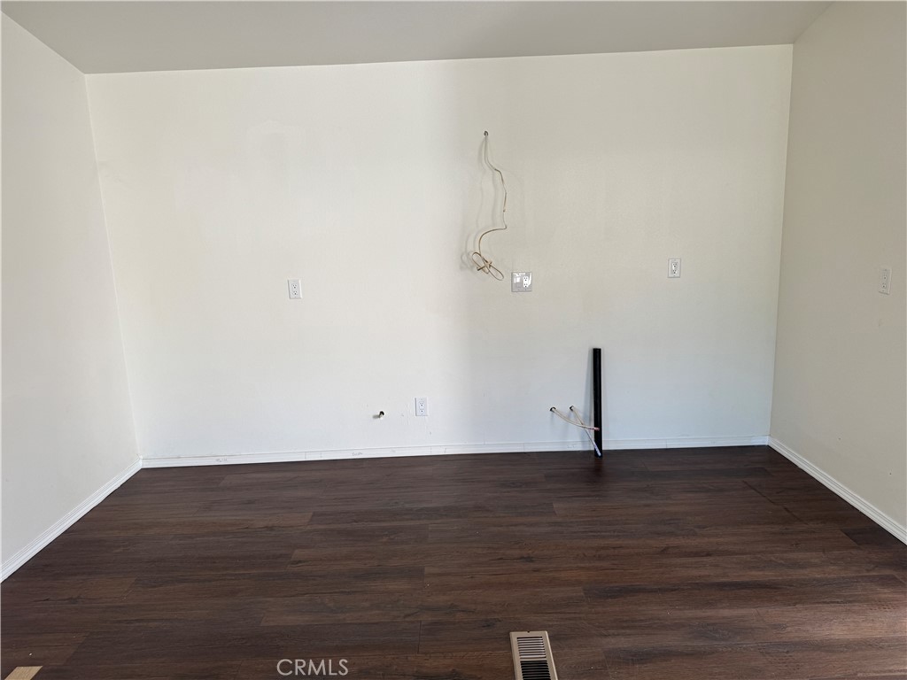 28110 Winchester Road Winchester, CA 92596 - Photo 6 of 36 a view of an empty room with wooden floor