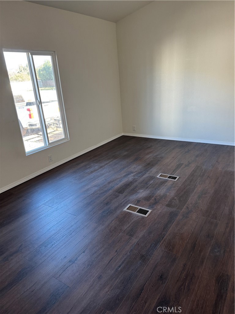 28110 Winchester Road Winchester, CA 92596 - Photo 10 of 36 an empty room with wooden floor and windows