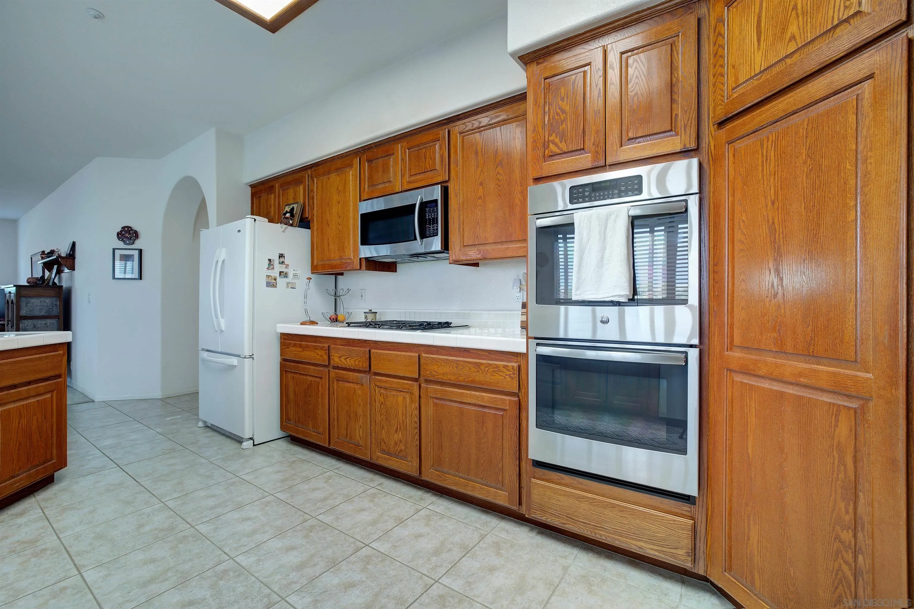 30578 Roadrunner Ridge Valley Center, CA 92082 - Photo 11 of 29 a kitchen with stainless steel appliances granite countertop a refrigerator and a stove top oven
