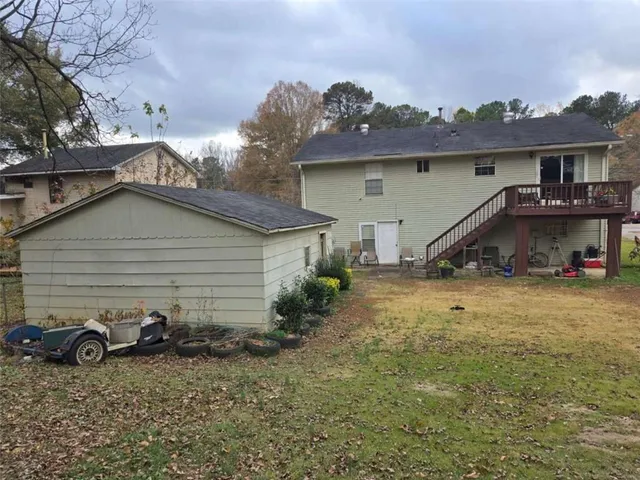 a view of a house with a yard and sitting area