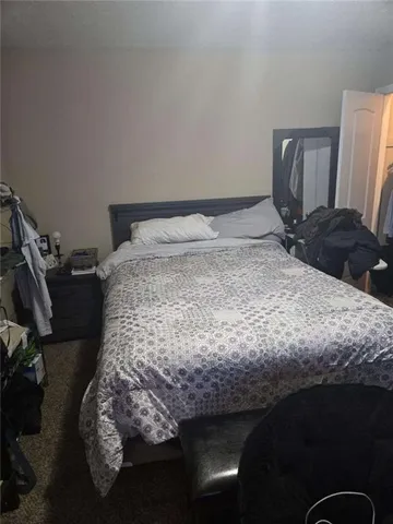 a bed sitting in a bedroom next to a window