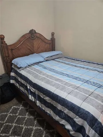 a bedroom with a bed and a mirror