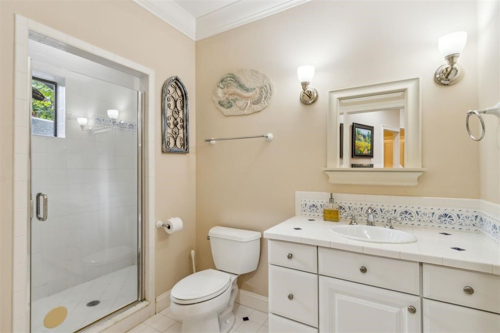 3119 Sea Marsh Road Fernandina Beach, FL 32034 - Photo 17 of 41 a bathroom with a granite countertop sink a toilet and a mirror