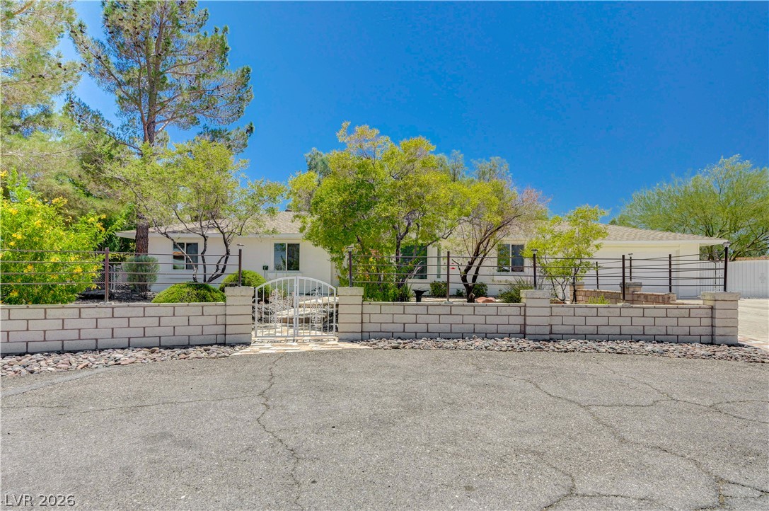 7631 Bermuda Road Las Vegas, NV 89123 - Photo 2 of 64 A private, gated home with mature trees offers tranquil living and security.