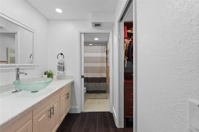 a bathroom with a double vanity sink and a mirror