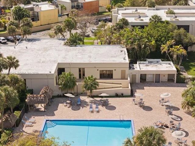 an aerial view of residential building with green space