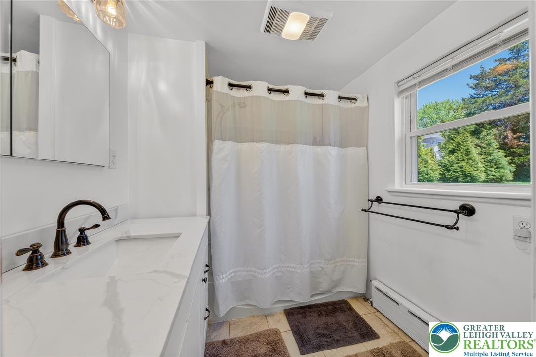 1411 Lieb Road Easton, PA 18040 - Photo 24 of 46 A window-filled bathroom showcasing a large vanity and shower.