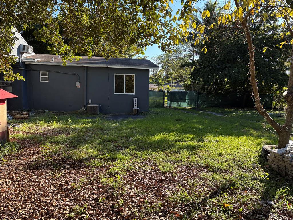 45 Northeast 146th Street, Unit B Miami, FL 33161 - Photo 15 of 16 a view of a backyard with plants and large trees